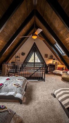 an attic bedroom with two beds and a lofted area in the ceiling is shown