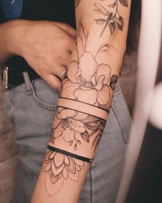 a woman's arm with flowers on it