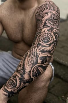 a man's arm with roses and an eagle tattoo on the left side of his arm