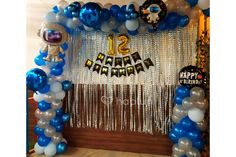 balloons and streamers decorate the entrance to a birthday party