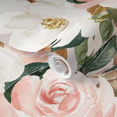 a wallpaper with white and pink flowers on the side, next to a roll of tape