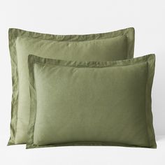 two green pillows sitting next to each other