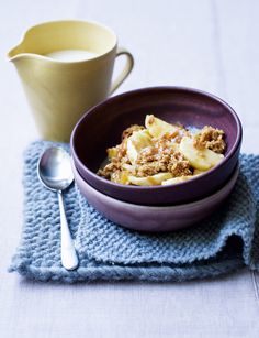 a bowl filled with food sitting on top of a blue cloth next to a cup