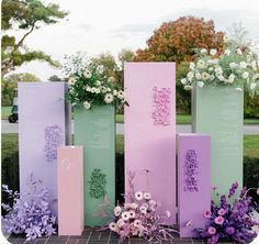 three tall vases with flowers and writing on them sitting in front of each other