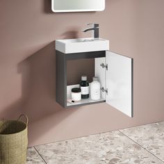 a bathroom with a sink, mirror and soap dispenser on the wall