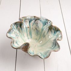 a blue and white bowl sitting on top of a wooden floor