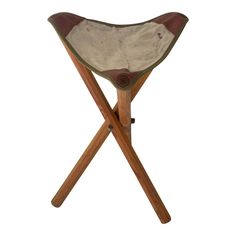 a wooden chair with a white seat and brown leather back cover on it's legs