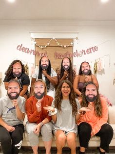 a group of people sitting on top of a couch posing for a photo with fake faces