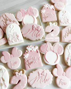 some pink and white decorated cookies with minnie mouse designs on them for a baby shower