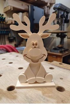 a wooden reindeer sitting on top of a table