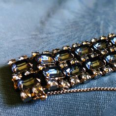 6 3/4" long, 1 1/4" wide. 30 large, blue Rhinestones lined with 87 light blue smaller Rhinestones.  It really is a glittering showpiece. Something Marilyn Monroe would wear in "Gentlemen Prefer Blondes". or "Diamonds Are A Girls Best Friend".  Comes in a bracelet box with a clasp and a mirror on the inside lid. Gentlemen Prefer Blondes, Bracelet Box, Wide Bracelet, Wedding Jewelry Bracelets, Blue Rhinestones, Wedding Bracelet, Girls Best Friend, Marilyn Monroe, Denim Blue