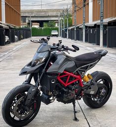 a motorcycle is parked in an empty parking lot