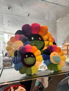 a display case filled with lots of colorful stuffed animals