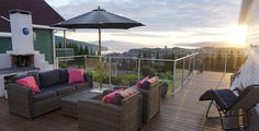 a patio with furniture and an umbrella on the deck