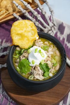 a bowl of chicken tortilla soup with sour cream