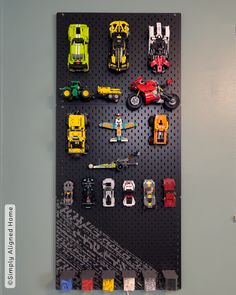 a peg board with cars and trucks on it