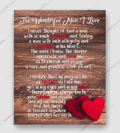 a wooden plaque with two hearts on it and the words,'i love you more than