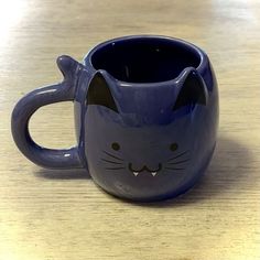 a blue mug with a cat face on it