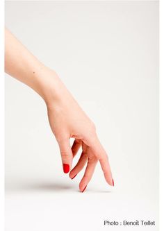 a person's hand reaching for something on a white surface with the word photo below it