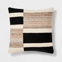 a black and white striped pillow sitting on top of a table