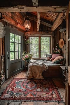 a bedroom with wooden walls and flooring has a large rug on the floor