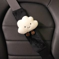 a car seat belt with a stuffed cloud on it