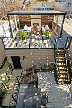 an aerial view of a house with stairs leading up to the second floor and patio