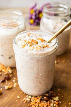 two jars filled with food sitting on top of a wooden table