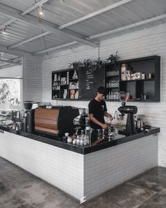 a man standing at the counter in a coffee shop