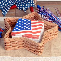 an american flag is in a basket on the floor next to other patriotic items and decorations