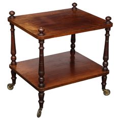 an old wooden table with wheels on the bottom and one shelf below it, isolated against a white background