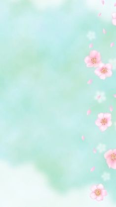 pink flowers are floating in the air on a blue and green background with space for text