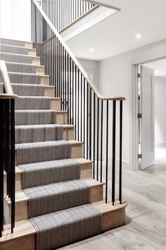 a staircase with black and white striped carpet