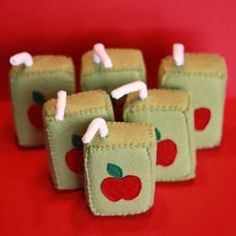 small green apples are sitting on top of each other with toothpicks sticking out of them