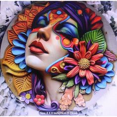 a woman's face painted with colorful flowers and leaves