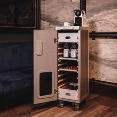 an open refrigerator sitting on top of a wooden floor