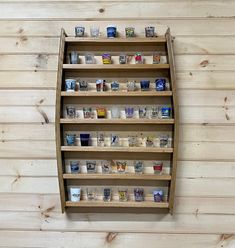 a wooden shelf filled with lots of cups