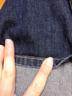 a person with their hand on the pocket of a pair of jeans