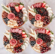 four platters filled with different types of fruits and vegetables on top of each other