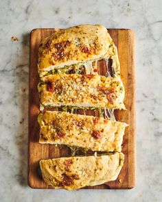 slices of pizza sitting on top of a wooden cutting board