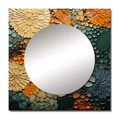 a mirror that is sitting on top of a tile wall with flowers and leaves around it