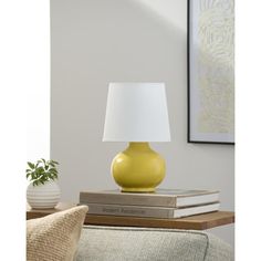 a yellow lamp sitting on top of a stack of books