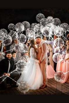 a bride and groom kissing in front of bubbles on the ground at their wedding reception