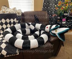 the couch is covered in black and white checkered blankets