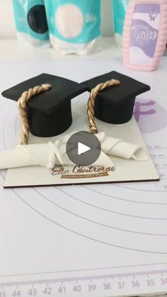 graduation cap and diploma on top of a piece of paper with twine around it