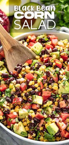 A close up view of a bowl of black bean and corn salad with avocado and cilantro. There's a wooden spoon in the salad bowl ready to serve out a helping. Corn Bean Avocado Salad, Black Bean Corn Cilantro Salad, Corn Salad Avocado, Corn Bean Tomato Salad, Southwestern Black Bean Salad, Black Bean Corn Recipes, Mexican Black Bean Corn Salad, Beans And Vegetables, Bean And Corn Recipes