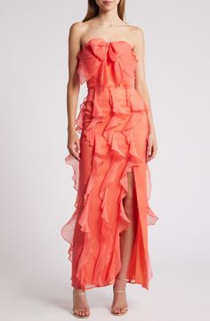 a woman wearing an orange dress with ruffles