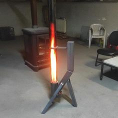 a stove that is sitting in the middle of a room with some chairs around it