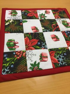 a quilted table top with christmas decorations on it