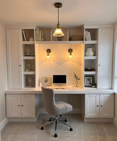 a home office with built - in shelving, desk and chair